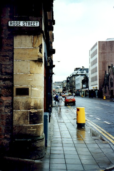 The plaque mounted on the corner of Rose St and Academy St.